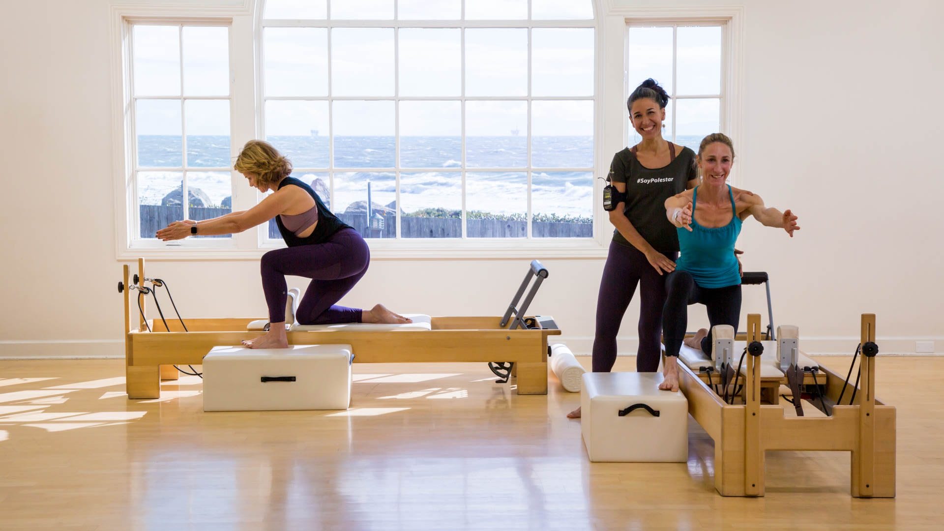 Polestar Senior Educator Christi Idavoy instructing students on the Pilates Reformer during a workshop.
