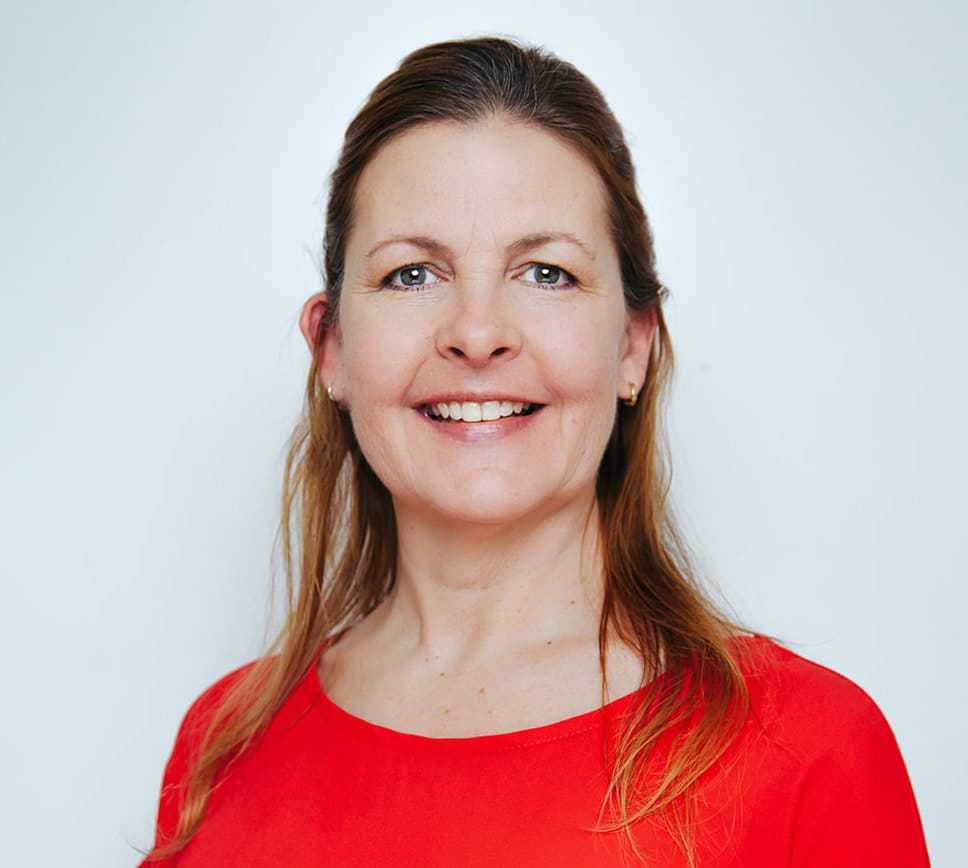 Shelly Power, Polestar USA Faculty Manager, wearing a red shirt against a light background.